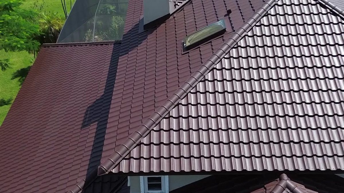 Worthouse steel tile roof in burgundy on a canal home — Horizon Commercial Roofing