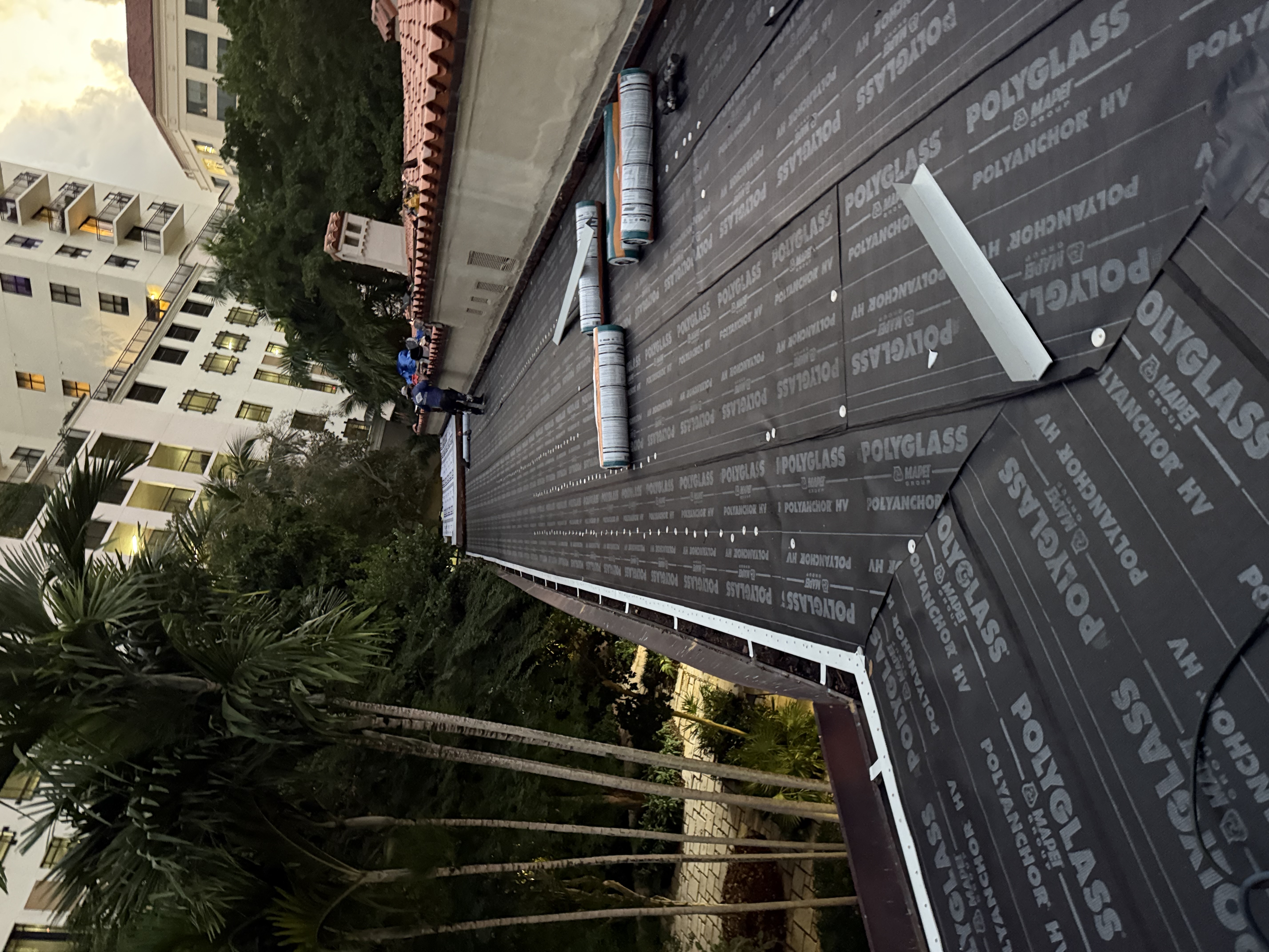 Technician installing Polyglass PolyAnchor HV flat roof coastal SWFL
